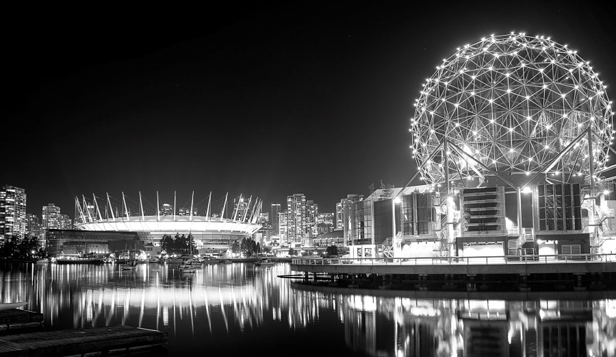 Vancouver at night, with BC Place stadium and Science World reflected in False Creek